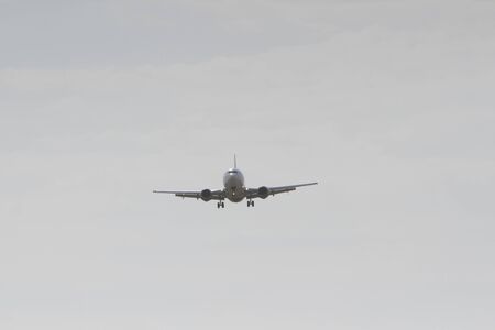 BUCHAREST, ROMANIA - August 15, 2017: Airplane in the cloudy sky.のeditorial素材