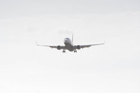 BUCHAREST, ROMANIA - August 15, 2017: Airplane in the cloudy sky.のeditorial素材