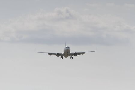 BUCHAREST, ROMANIA - August 15, 2017: Airplane in the cloudy sky.のeditorial素材
