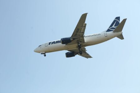 BUCHAREST, ROMANIA - August 15, 2017: Airplane in the cloudy sky.のeditorial素材