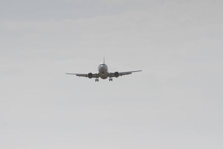 BUCHAREST, ROMANIA - August 15, 2017: Airplane in the cloudy sky.のeditorial素材