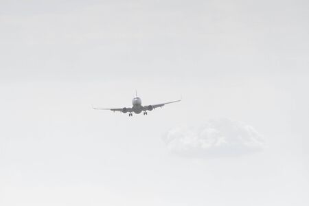 BUCHAREST, ROMANIA - August 15, 2017: Airplane in the cloudy sky.のeditorial素材