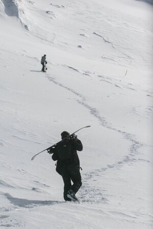 SIBIU, ROMANIA - March 13, 2010: A skier walks on the Fagaras mountains and carrying his skisのeditorial素材
