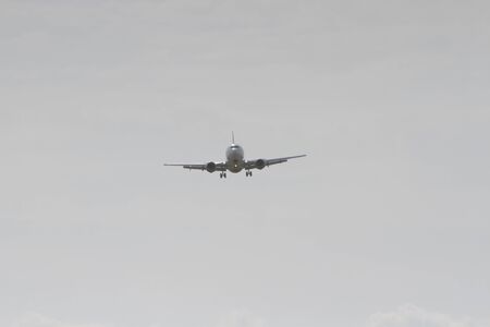 BUCHAREST, ROMANIA - August 15, 2017: Airplane in the cloudy sky.のeditorial素材