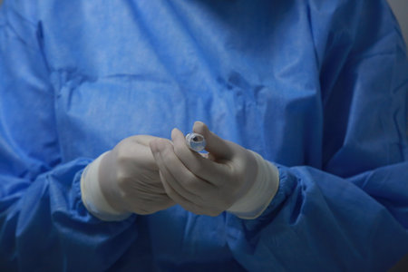 BUCHAREST, ROMANIA - Dec. 27, 2020: A nurse prepares a dose of the Pfizer-BioNTech COVID-19 vaccine during the first day of European Vaccination Campaign.のeditorial素材