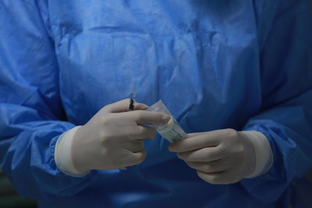 BUCHAREST, ROMANIA - Dec. 27, 2020: A nurse prepares a dose of the Pfizer-BioNTech COVID-19 vaccine during the first day of European Vaccination Campaign.のeditorial素材