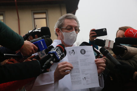 BUCHAREST, ROMANIA - Dec. 27, 2020: Professor Adrian Streinu-Cercel shows to press the vaccination ceritificate during the first day of European Vaccination Campaign.のeditorial素材