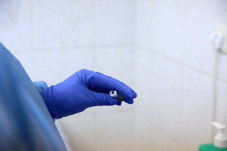BUCHAREST, ROMANIA - Dec. 27, 2020: A nurse prepares a dose of the Pfizer-BioNTech COVID-19 vaccine during the first day of European Vaccination Campaign.のeditorial素材