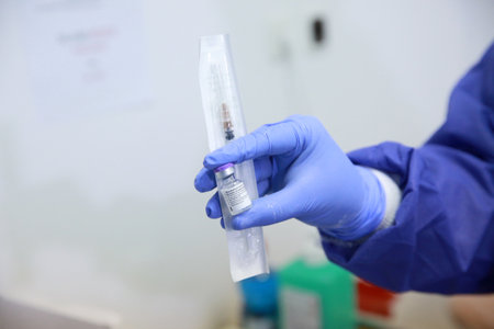 BUCHAREST, ROMANIA - Dec. 27, 2020: A nurse presents a dose of the Pfizer-BioNTech COVID-19 vaccine during the first day of European Vaccination Campaign.のeditorial素材