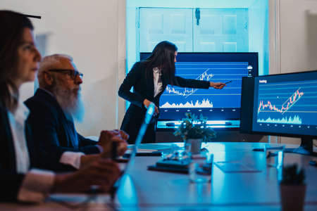 Businesswoman conducting presentation for colleagues