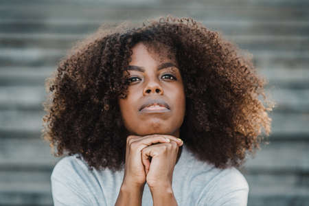 Young african looking at camera outdoor in the city - Focus on faceの写真素材