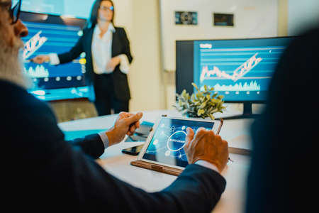 Trader team doing blockchain research inside hedge fund office - Focus on tabletの写真素材