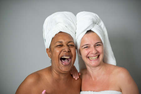 Excited diverse female friends during spa sessionの写真素材