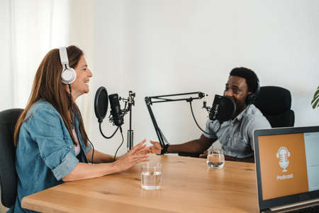 Multiethnic colleagues recording podcast in studio