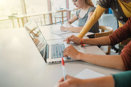 Crop students doing homework togetherの写真素材