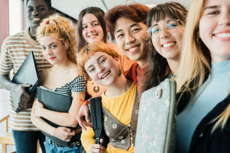 Diverse teen students taking selfie together