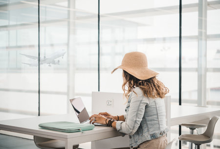 Anonymous female freelancer working in airportの写真素材