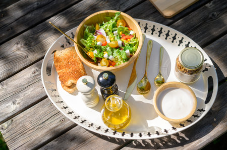 Delicious healthy breakfast served on wooden table in gardenの写真素材