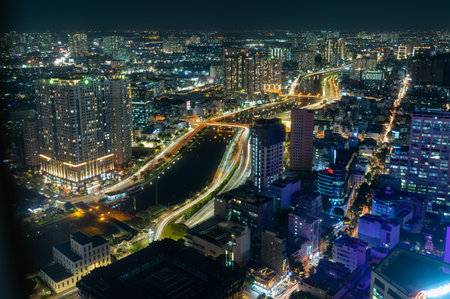 Illuminated skyscrapers in city view at nightの写真素材
