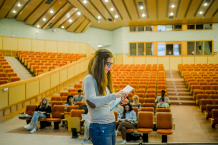 Serious woman standing with notebook in conference roomの写真素材