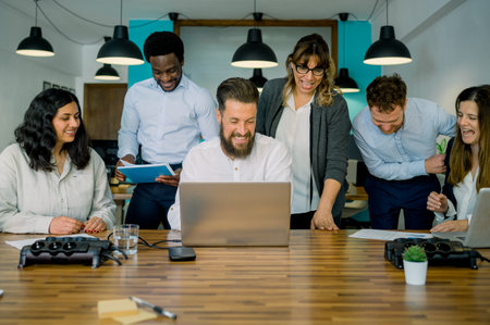 Happy diverse coworkers smiling during business discussion in officeの写真素材