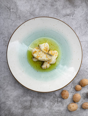 White fish served with green sauce on plateの写真素材