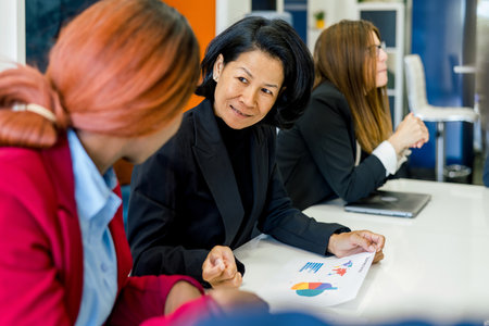 Group of diverse colleagues analyzing business with statistics in officeの写真素材