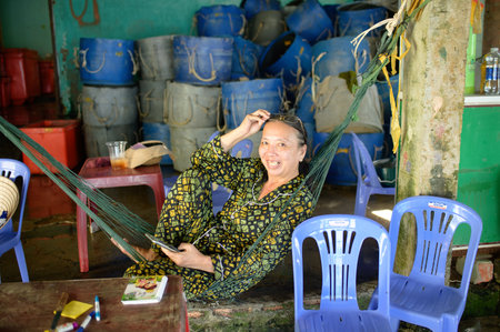 Young woman sitting at tableのeditorial素材
