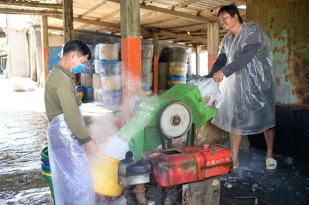Men at work crushing ice at a local fishmongerのeditorial素材