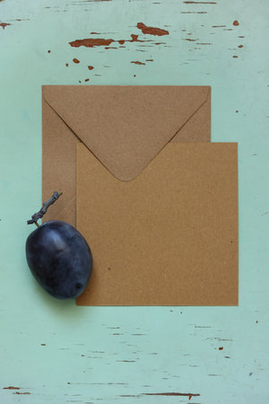 Grapes and envelope on wooden background. Top view with copy space