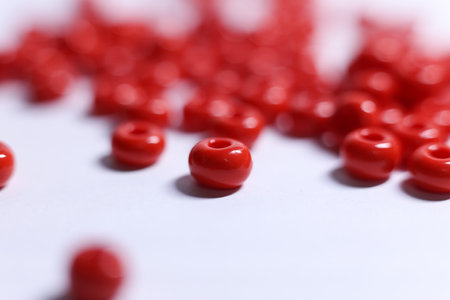 Red beads on a white background. Close-up. Selective focus.の写真素材