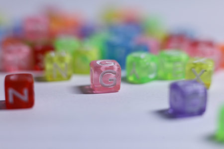 Close up of multicolored toy cubes with letters on white backgroundの写真素材
