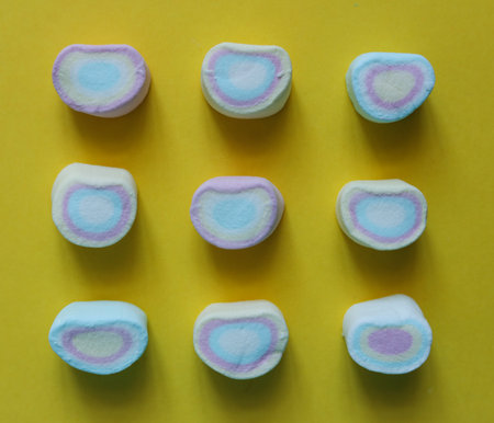 Colorful marshmallows on a yellow background. Top view.の写真素材