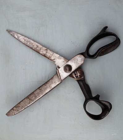 Old scissors on a wooden background. Vintage style. Top view.の写真素材