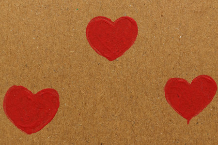 Red hearts on brown paper background. Valentines day background. Love concept.の写真素材