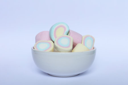 Colorful marshmallows in a bowl on a white background.の写真素材