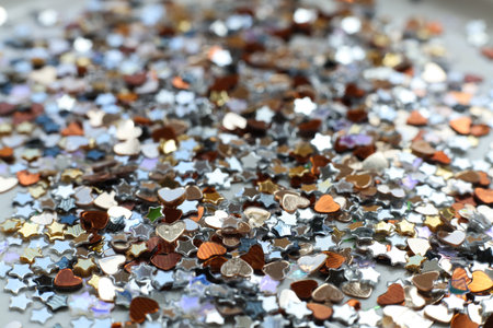 Multicolored confetti background. Many small shiny stars and hearts on a white background.