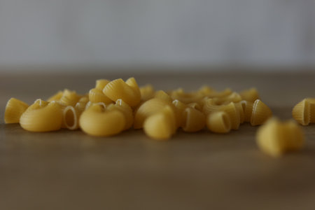 Macaroni on a wooden background. Close up. Selective focus.