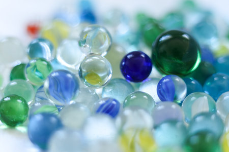 Colorful glass marbles on a white background. Selective focus.