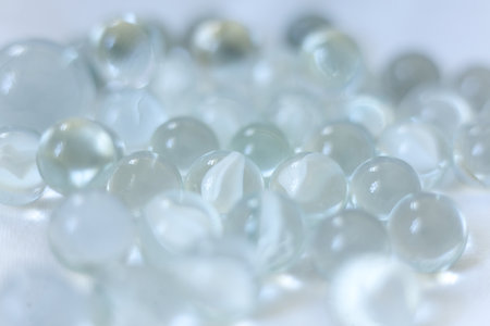 clear Glass marbles on a white background, close-up, selective focusの写真素材