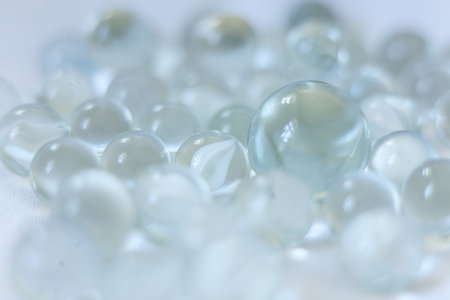 clear Glass marbles on a white background, close-up, selective focusの写真素材