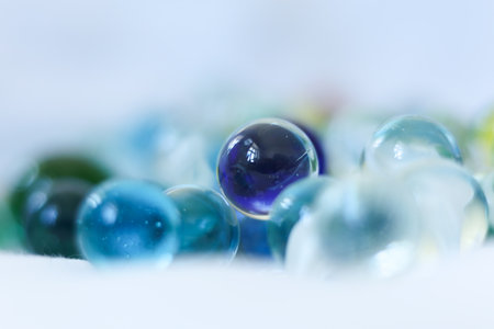 Colorful glass marbles on a white background. Selective focus.の写真素材
