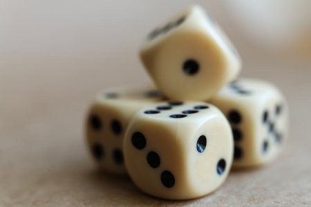 Dice on beige background with shallow depth of field and copy spaceの写真素材