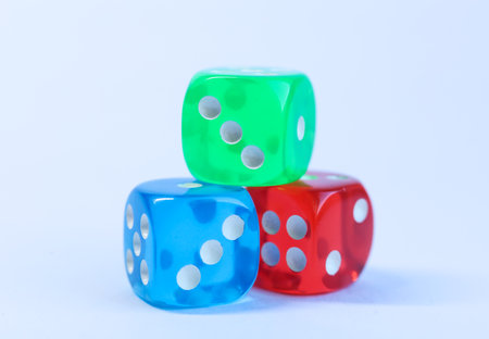 Colorful dices on a white background, closeup of photoの写真素材