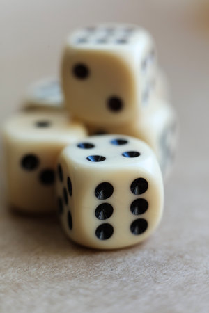 Dice on beige background with shallow depth of field and copy spaceの写真素材