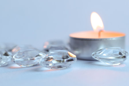 Candle and crystal stones on white background. Copy space for text.の写真素材
