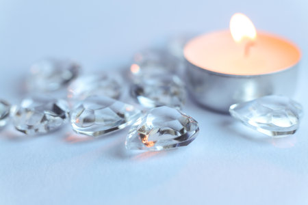 Candle and crystal stones on white background. Copy space for text.の写真素材