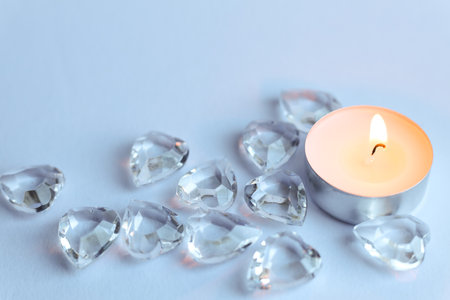 Candle and crystal stones on white background. Copy space for text.の写真素材