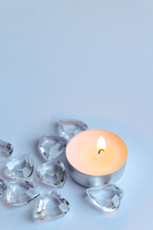 Candle and crystal stones on white background. Copy space for text.の写真素材