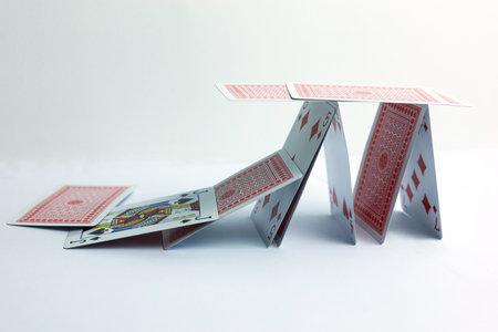 Playing cards in the form of a tower on a white background.
